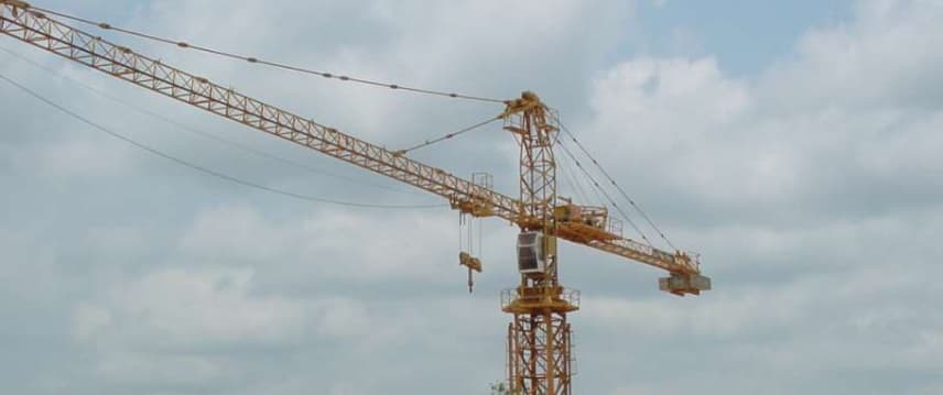 Tower crane erecting bridge parapets on a company project site